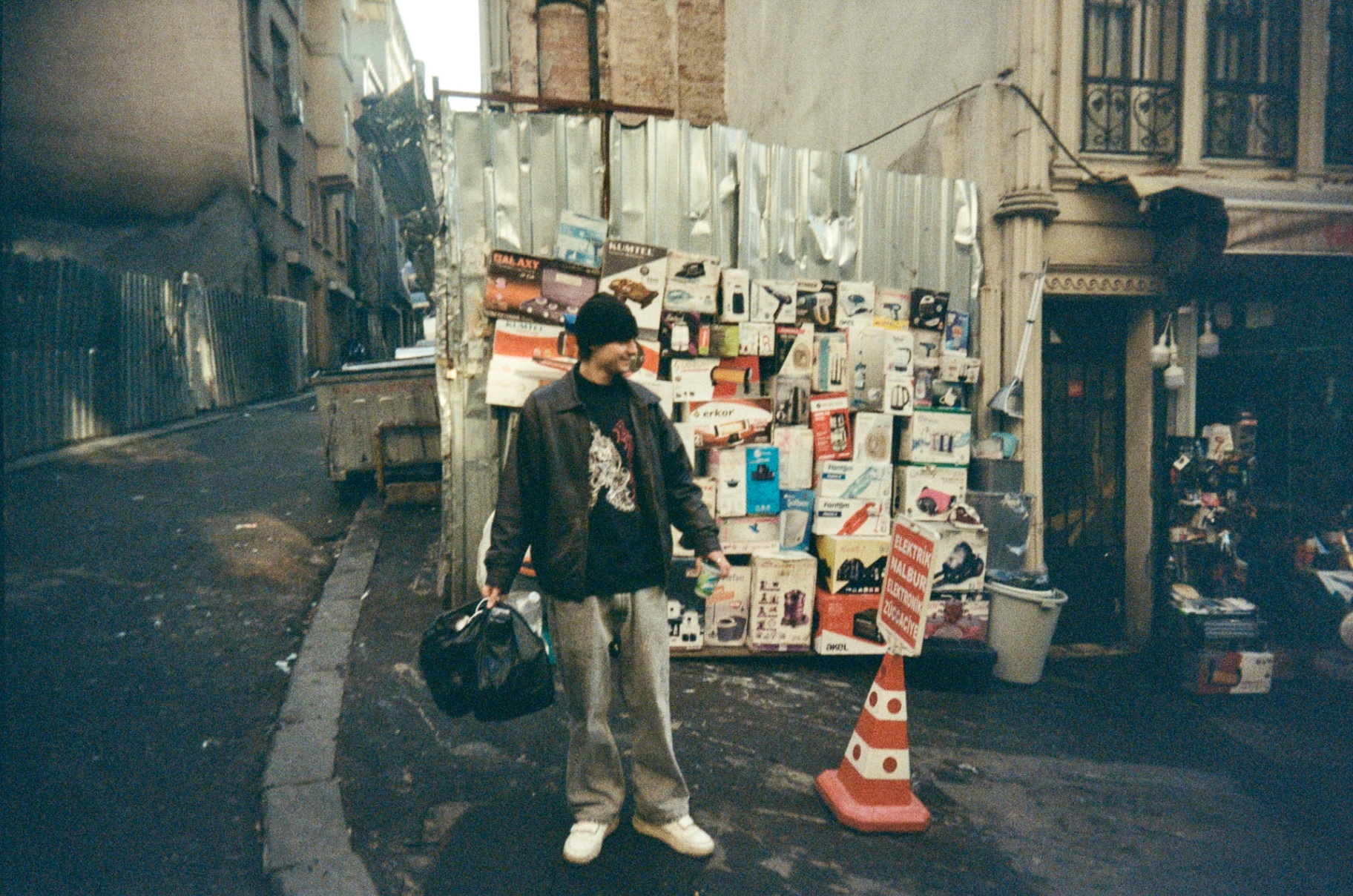 Friend standing in front of an electronics shop in Istanbul, shot on 35mm film
