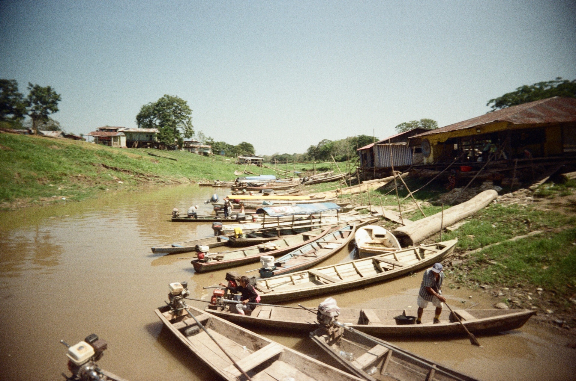 Wooden boats on a muddy river, shot on 35mm film